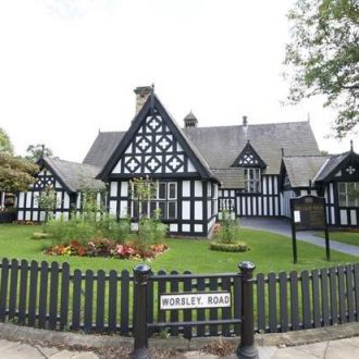 View of The Court House, Worsley from Worsley road entrance with a view of the small grassed area.