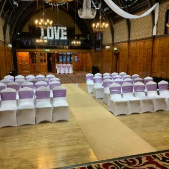 Wedding ceremony in beautiful room with wood panelled walls chandelier canopy