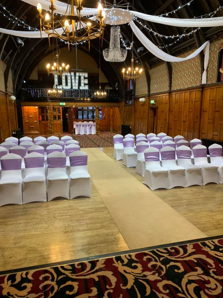 Wedding ceremony in beautiful room with wood panelled walls chandelier canopy
