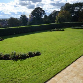 paved patio and large landscaped garden