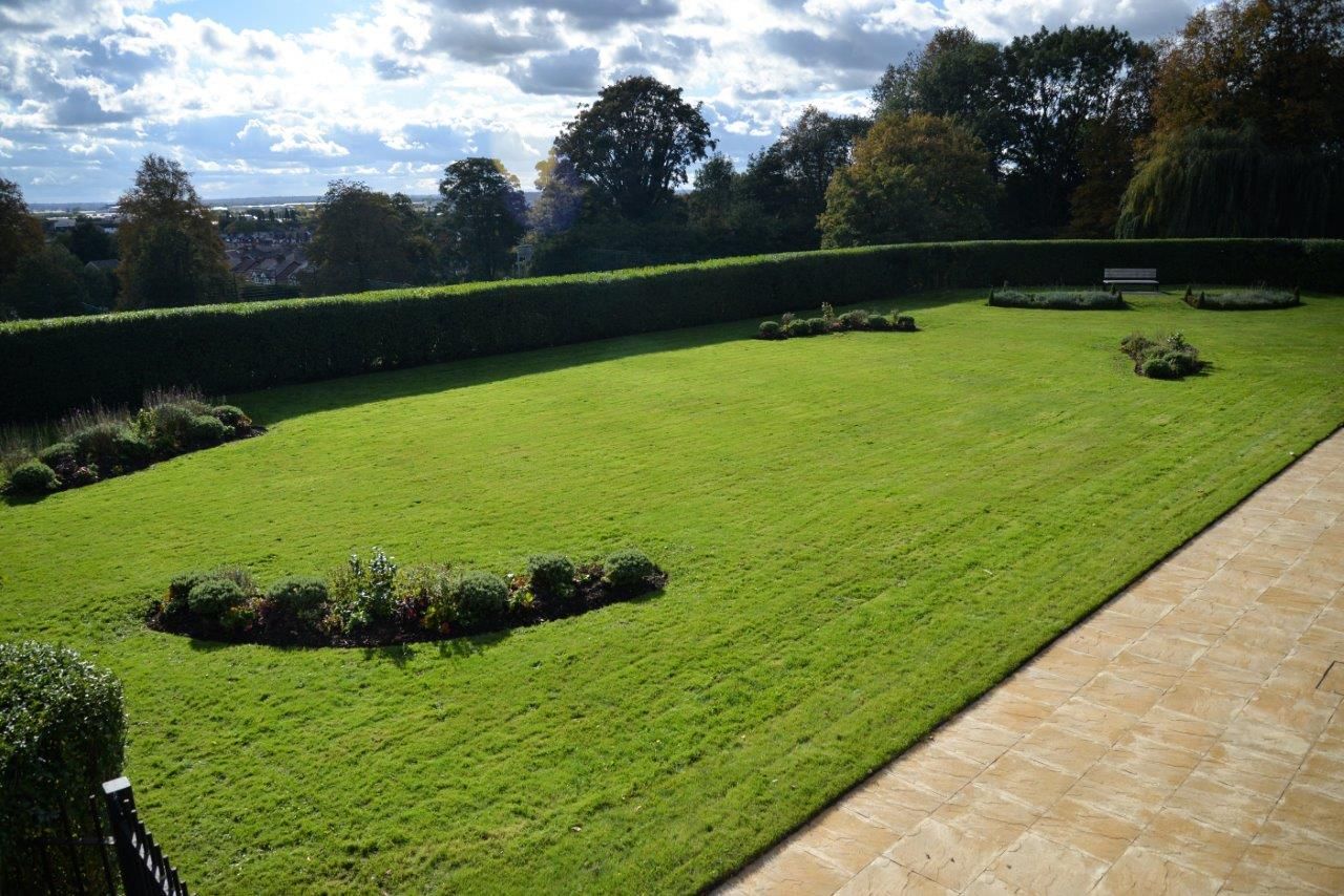 paved patio and large landscaped garden